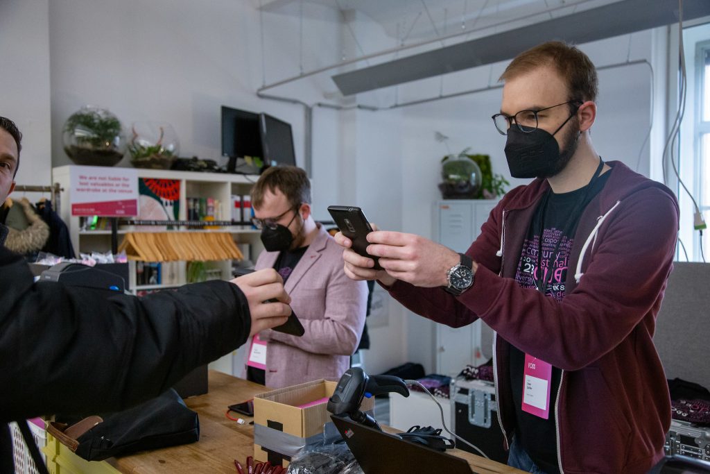 Checkin counter at FOSS Backstage: Two people scanning tickets